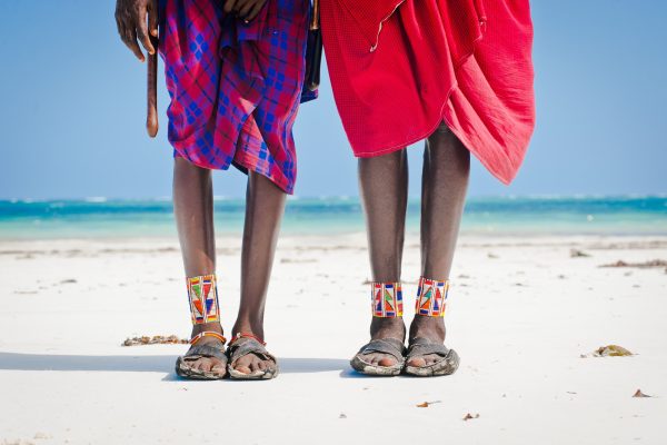 feet men the Masai tribe in shoes made of car tires on the backdrop of the ocean